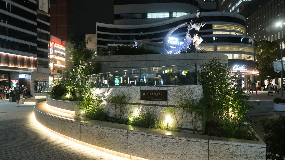 The Godzilla statue at Godzilla Square in Hibiya, Tokyo, lit up at night near Toho's head office