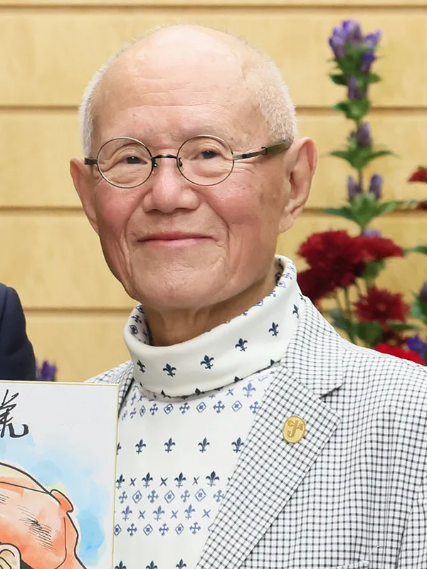 Manga artist Tetsuya Chiba in 2023, wearing glasses and a dark suit